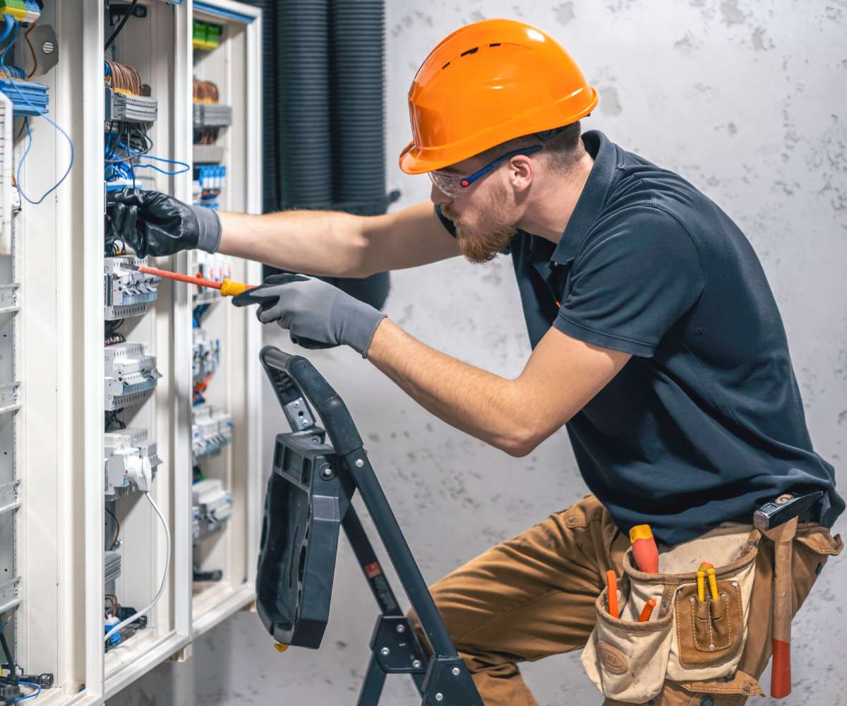 electrician-civil-engineer-screwing-equipment-into-fuse-box
